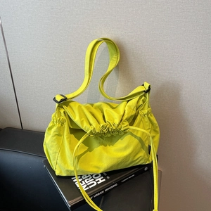 Neon yellow drawstring shoulder bag with pleated nylon fabric and adjustable strap