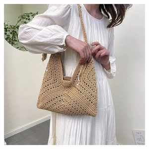 Detail of hand-woven straw shoulder bag with V-pattern crochet and thick braided strap