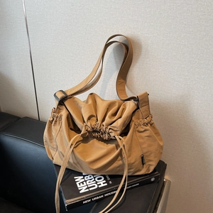 Minimalist large-capacity khaki canvas crossbody bag with drawstring closure and wide strap