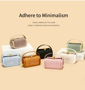 Close-up of stylish saddle bags in seven colors with herringbone weave and gold buckles