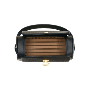 Overhead view of cylindrical black bag with striped lining and gold metallic clasp