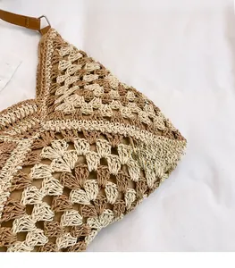 Close-up of geometric woven pattern in cream and tan with leather strap detail