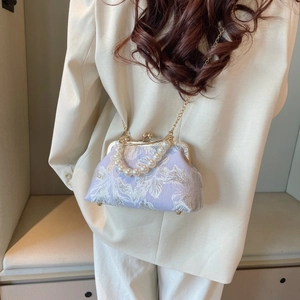 Detail of light purple floral jacquard shell bag with large pearl handle and gold chain