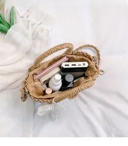 Internal view of straw woven handbag showing spacious storage capacity with fabric lining