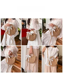 Detail view of woven straw half-moon bag with large white lace bow and ring handle