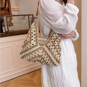 Close-up of a crochet woven shoulder bag with geometric patterns on a lifestyle model