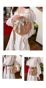 Detailed close-up of straw woven crossbody bag featuring a delicate white lace bow