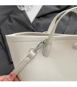Detailed close-up of premium white bucket bag with silver turn-lock and leather texture