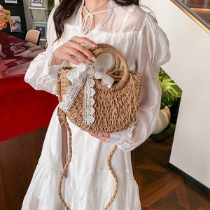 Straw woven handbag with white lace bow and drawstring closure for French pastoral style