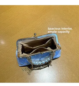 Detail view of the spacious inner lining and pocket layout of this shell evening bag
