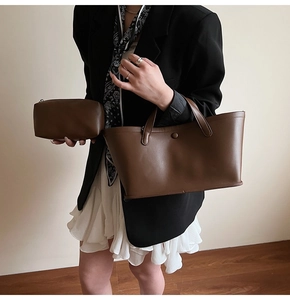 Brown leather tote bag set styled with a blazer and pleated skirt for office look