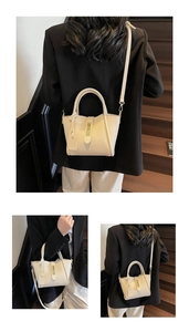 Detail of off-white lychee grain leather handbag with adjustable crossbody strap