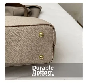 Macro shot of wear-resistant tote bag bottom with protective gold metal feet studs