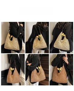 Detail of hollow woven straw tote bag featuring decorative wooden beads and round handle rings