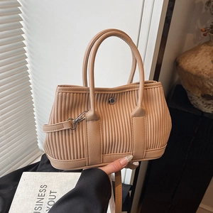 Minimalist beige corduroy bucket bag with faux leather handles and detachable strap