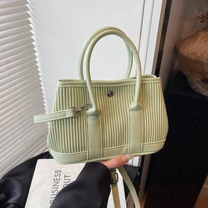 Light green pleated bucket bag with dual handles and adjustable shoulder strap