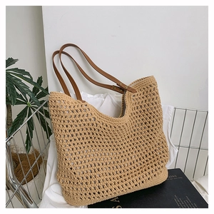 Detail of hollow-out woven texture on beige tote bag with premium brown leather handles