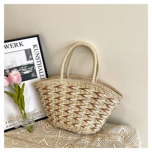 Close-up of geometric woven straw pattern and texture on a beige tote bag