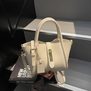 Minimalist cream white lychee leather tote bag with gold buckle and adjustable strap