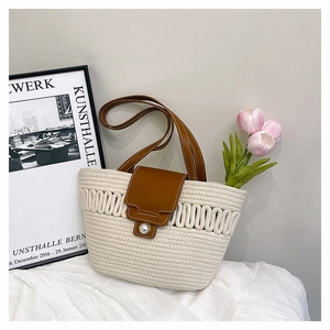 Detail of woven tote bag featuring white cotton rope texture and a pearl clasp closure