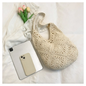 Detailed knit pattern on beige crochet shoulder bag with spacious interior for tablets