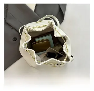 Top view of spacious white bucket backpack interior showing daily essentials and chain