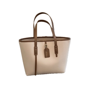 Large cream tote bag with brown straps and pebble leather texture for women