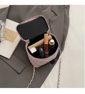 Pink quilted mini bag interior showing capacity for lipstick and beauty products