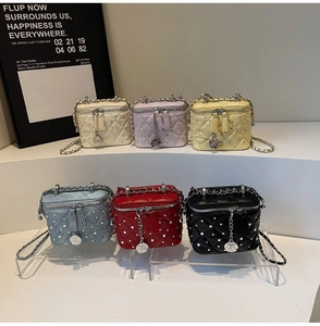 Quilted mini vanity bags in six colors with metal chains and camellia charms details