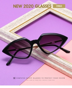 Detail view of triangular ocean lenses on metal sunglasses with purple gradient tint