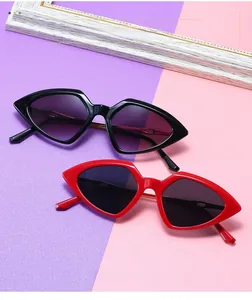 Detail view of trendy geometric triangle sunglasses in black and red glossy frames