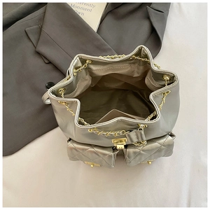 Top view of silver metallic bucket bag with chain drawstring and quilted pockets
