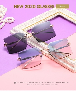 Detailed close-up of rimless square sunglasses with gradient lenses and gold metal temples