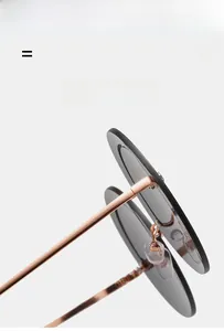 Détail de lunettes de soleil rondes avec branches en métal rose doré et cadre léger