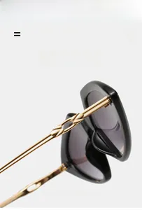 Detail of metal chain-link hinge and temples on black lightweight sunglasses