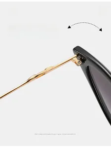 Detail of durable gold metal hinge and thick black frame on retro sunglasses