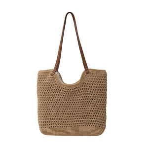 Fashionable woven straw tote bag with brown leather handles for summer travel
