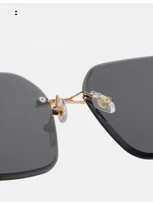 Macro detail of comfortable silicone nose pads and gold metal bridge on rimless sunglasses