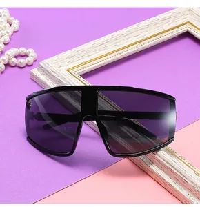 Close-up of stylish oversized cycling sunglasses with a dark purple one-piece lens
