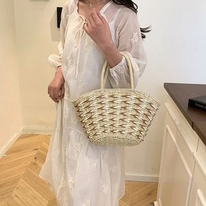 Large woven straw tote bag with wave pattern and circular handles for summer beach travel
