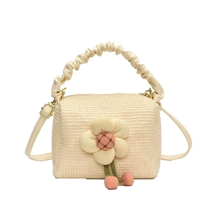 Chic beige straw beach bag with large fabric flower and ruffled leather handle