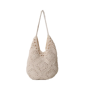 Chic cream handmade crochet tote bag with intricate floral knit texture for summer beach use