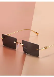 Detail of gold metal temples with interlaced hollow patterns on rectangular sunglasses