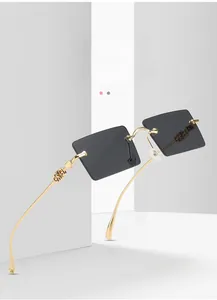 Detailed close-up of golden metal temples with hollow-out logo on rectangular sunglasses