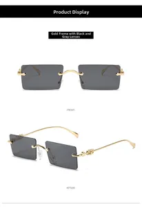 Detail view of gold metal temples with hollow floral patterns on square gray sunglasses