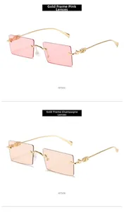 Detail view of pink and champagne rectangle sunglasses with gold metal frames and temples