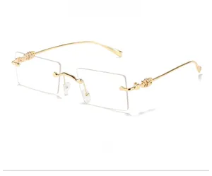 Detail of gold metal hinge with C-shape decor on rectangular rimless sunglasses