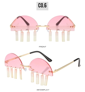 Close-up of pink semi-rimless sunglasses with gold frames and dangling tassel charms