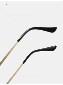 Detail view of golden metal temple arms with curved black tips for comfortable wear