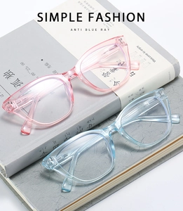 Detail of pink and blue stylish large frame anti-blue light glasses on stacked books